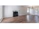 Spacious living room with hardwood flooring, a fireplace, and access to the outside through French doors at 4968 Windsor Downs Ln, Decatur, GA 30035