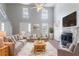 Bright and airy living room with soaring ceilings, a fireplace, and large windows for natural light at 4968 Windsor Downs Ln, Decatur, GA 30035