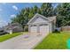 Exterior view showcasing a two-car garage, lush lawn, and a traditional architectural design at 4968 Windsor Downs Ln, Decatur, GA 30035