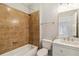 This bathroom features a shower over tub with tan tiling, a modern vanity, and a tiled floor at 898 Oak Sw St # 3228, Atlanta, GA 30310