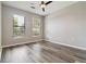 Bright bedroom featuring wood floors, neutral walls, and large windows with blinds at 898 Oak Sw St # 3228, Atlanta, GA 30310