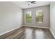 This bedroom features a ceiling fan, lots of natural light from the two windows, and wood-look flooring at 898 Oak Sw St # 3228, Atlanta, GA 30310