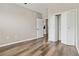 Bedroom featuring closet, wood floors, neutral walls, and door to the kitchen at 898 Oak Sw St # 3228, Atlanta, GA 30310