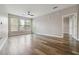 Bright living room with wood floors and neutral walls leads to balcony and hall at 898 Oak Sw St # 3228, Atlanta, GA 30310