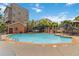 This community pool features resort-style seating, a brick pool house, and multiple umbrellas at 898 Oak Sw St # 3228, Atlanta, GA 30310