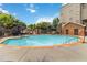 This community pool features resort-style seating, a brick pool house, and lounge chairs at 898 Oak Sw St # 3228, Atlanta, GA 30310