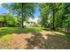 Expansive backyard with lush green grass, mature trees, and a full fence at 2706 Del Ridge Dr, Douglasville, GA 30135