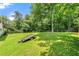 Large, grassy backyard featuring mature trees and an inviting deck with wooden stairs at 2706 Del Ridge Dr, Douglasville, GA 30135