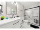 Modern bathroom features a white vanity, black fixtures, and a glass-enclosed shower with marble-like tile at 2706 Del Ridge Dr, Douglasville, GA 30135