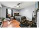Cozy bedroom with wood floors, a ceiling fan, a comfy bed, and a gaming chair at 2706 Del Ridge Dr, Douglasville, GA 30135