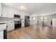 Open kitchen and dining area with modern appliances and white cabinets at 2706 Del Ridge Dr, Douglasville, GA 30135