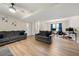 Spacious living room with wood floors, sofas, a ceiling fan, and access to a stairway at 2706 Del Ridge Dr, Douglasville, GA 30135