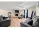Comfortable living room with sofas, a fireplace, a TV, and wood flooring at 2706 Del Ridge Dr, Douglasville, GA 30135