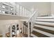 View of the wood-trimmed staircase with white railings leading to an open landing area at 2706 Del Ridge Dr, Douglasville, GA 30135