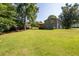 Expansive backyard with lush lawn, deck, and a two-story home with a convenient attached garage at 2880 Brett Nw Cir, Acworth, GA 30101