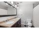 Bathroom with a granite-topped double vanity, modern lighting, and tiled floors at 2880 Brett Nw Cir, Acworth, GA 30101