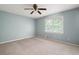 Neutral bedroom features light blue walls, carpet and a ceiling fan plus natural light from a window at 2880 Brett Nw Cir, Acworth, GA 30101