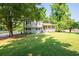 Shot of the two-story home with black shutters and a charming covered front porch at 2880 Brett Nw Cir, Acworth, GA 30101