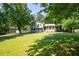 View of the two-story home surrounded by a lush green lawn and mature trees at 2880 Brett Nw Cir, Acworth, GA 30101