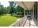 Inviting covered front porch with white railings overlooking a sprawling green lawn at 2880 Brett Nw Cir, Acworth, GA 30101