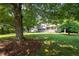 Well-maintained home with large front yard featuring mature trees and an inviting front porch at 2880 Brett Nw Cir, Acworth, GA 30101
