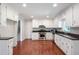 Well-lit kitchen with stainless steel appliances, granite counters, and ample cabinet space, with stairs visible at 2880 Brett Nw Cir, Acworth, GA 30101