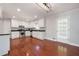 Open kitchen with granite countertops, stainless appliances, hardwood floors, and white cabinetry at 2880 Brett Nw Cir, Acworth, GA 30101