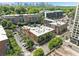Overhead shot of brick buildings surrounded by greenery and other modern buildings on a clear, sunny day at 650 Glen Iris Ne Dr # 26, Atlanta, GA 30308