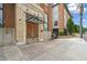 Beautiful building entrance with brick accents, glass and metal awning, and a concrete walkway at 650 Glen Iris Ne Dr # 26, Atlanta, GA 30308