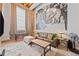 An industrially styled living room with high ceilings, exposed brick, and a large movie mural at 650 Glen Iris Ne Dr # 26, Atlanta, GA 30308