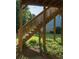 Backyard featuring a wooden staircase, a lawn, and surrounding trees, providing an inviting and relaxing outdoor space at 730 Midway Ave, Canton, GA 30114