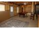 Basement featuring a pool table and a textured rug, providing a large space for relaxation and recreation at 730 Midway Ave, Canton, GA 30114