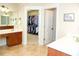 Bathroom featuring double sinks and a view of a large walk-in closet, providing ample storage and vanity space at 730 Midway Ave, Canton, GA 30114