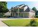 Inviting two-story home featuring a two-car garage and a lush green lawn at 730 Midway Ave, Canton, GA 30114