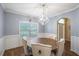 Elegant dining room with a modern chandelier, wainscoting, and hardwood floors at 85 Shiver Blvd, Covington, GA 30016