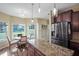 Bright kitchen with stainless steel appliances, granite countertops, and a breakfast nook with large windows at 85 Shiver Blvd, Covington, GA 30016