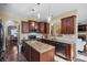 Well-equipped kitchen with dark wood cabinets, stainless steel appliances, and an island with granite countertop at 85 Shiver Blvd, Covington, GA 30016
