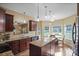 Spacious kitchen featuring dark wood cabinets, granite countertops, and a breakfast area with natural light at 85 Shiver Blvd, Covington, GA 30016