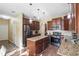Stylish kitchen with dark wood cabinets, granite countertops, stainless steel appliances, and an island at 85 Shiver Blvd, Covington, GA 30016
