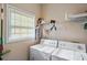 Functional laundry room with white appliances and plenty of storage space at 85 Shiver Blvd, Covington, GA 30016
