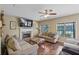 Cozy living room with a fireplace, hardwood floors, and comfortable sofas, ideal for entertaining guests at 85 Shiver Blvd, Covington, GA 30016