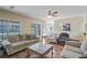 Inviting living room with hardwood floors, plush sofas, and a modern ceiling fan at 85 Shiver Blvd, Covington, GA 30016