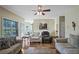 Comfortable living room with hardwood floors, large windows, and a view into the open kitchen at 85 Shiver Blvd, Covington, GA 30016
