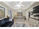 Spacious bedroom with a tray ceiling, luxurious bedding, and a sitting area at 85 Shiver Blvd, Covington, GA 30016