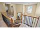Upper level staircase with decorative railings and view of the foyer below at 85 Shiver Blvd, Covington, GA 30016