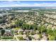 Expansive aerial view of a neighborhood with lush green trees and well-maintained homes at 2539 Sagebrush Trl, Buford, GA 30519