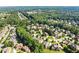 A scenic aerial view showcases a neighborhood with mature trees and well-maintained homes in a tranquil setting at 2539 Sagebrush Trl, Buford, GA 30519