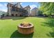 Well-maintained backyard featuring a stone fire pit, ideal for gatherings and enhancing outdoor living at 2539 Sagebrush Trl, Buford, GA 30519
