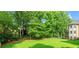 Expansive backyard featuring lush greenery and mature trees, creating a private and serene outdoor space at 2539 Sagebrush Trl, Buford, GA 30519