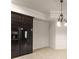 Basement dining area with chandelier, crown molding, tiled flooring and a stainless steel refrigerator at 2539 Sagebrush Trl, Buford, GA 30519